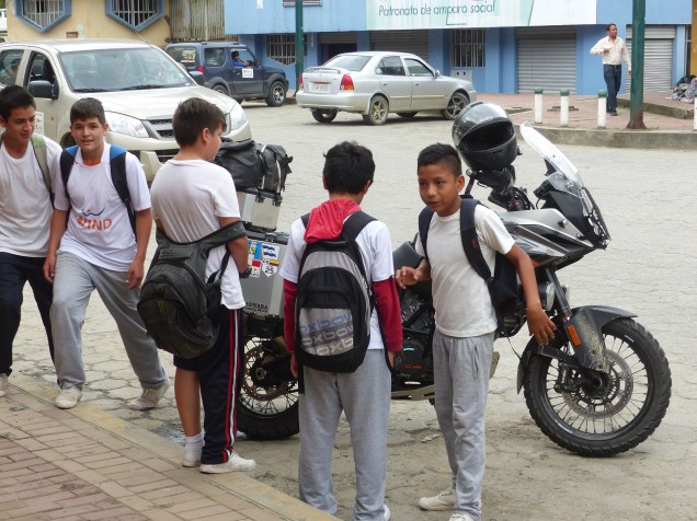 Boys inspecting the bike